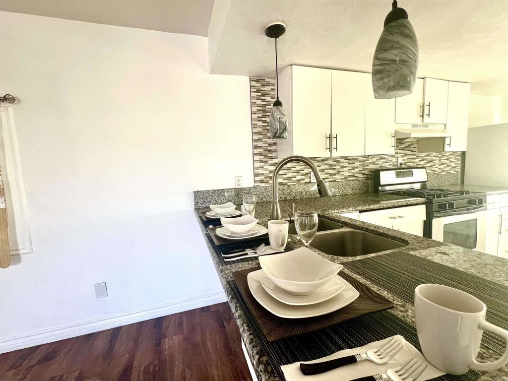 10707 Jamacha Boulevard, Unit 72 Spring Valley, CA 91978 - Photo 16 of 18 a view of a dining room with furniture and wooden floor