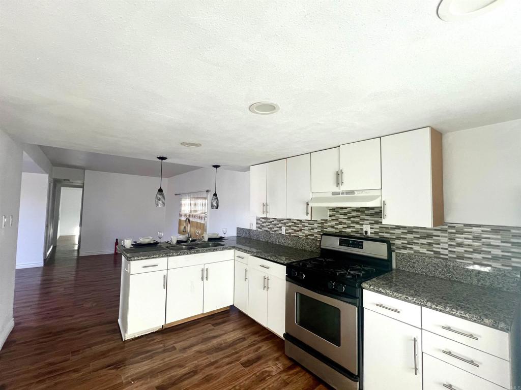 10707 Jamacha Boulevard, Unit 72 Spring Valley, CA 91978 - Photo 17 of 18 a kitchen with stainless steel appliances granite countertop a stove and a sink