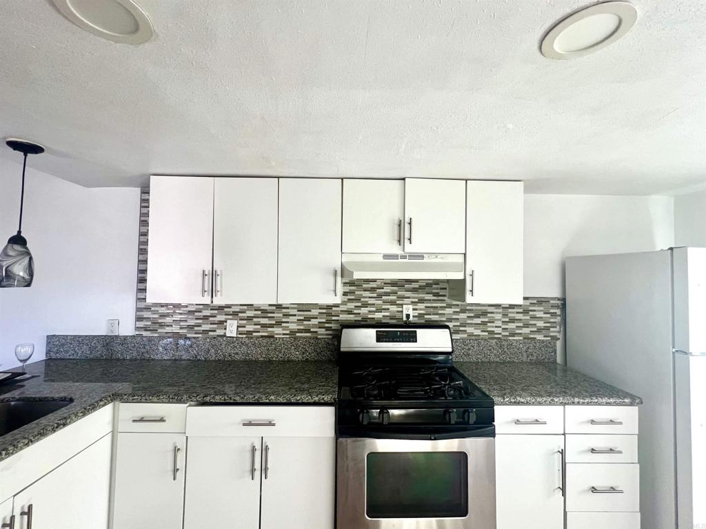 10707 Jamacha Boulevard, Unit 72 Spring Valley, CA 91978 - Photo 18 of 18 a kitchen with granite countertop a stove and a sink