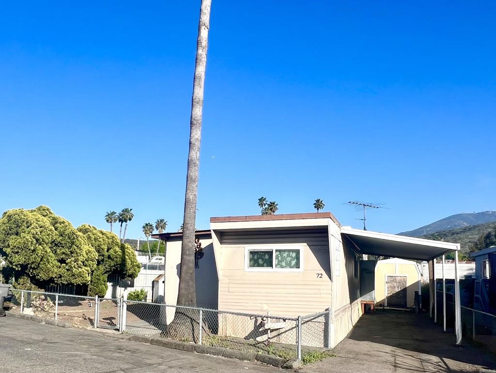 10707 Jamacha Boulevard, Unit 72 Spring Valley, CA 91978 - Photo 2 of 18 a view of a patio with table and chairs a barbeque with wooden fence
