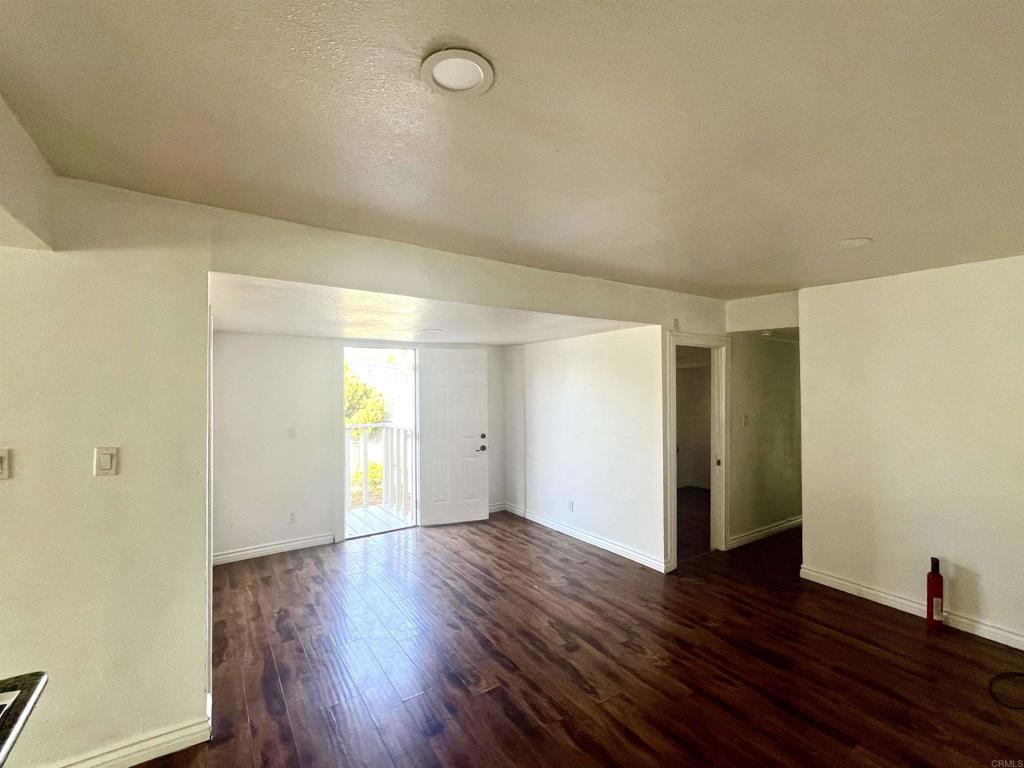 10707 Jamacha Boulevard, Unit 72 Spring Valley, CA 91978 - Photo 6 of 18 an empty room with wooden floor and windows