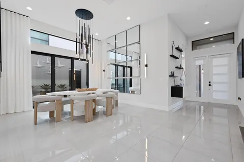a dining hall with couches a coffee table and chairs