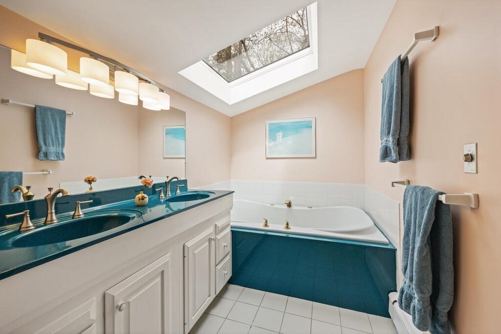16 Dee Road Lexington, MA 02420 - Photo 19 of 30 a bathroom with a granite countertop bathtub sink and mirror