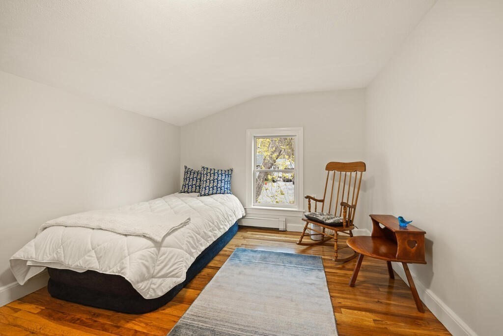 16 Dee Road Lexington, MA 02420 - Photo 24 of 30 a bedroom with a bed a chair and a couch with wooden floor