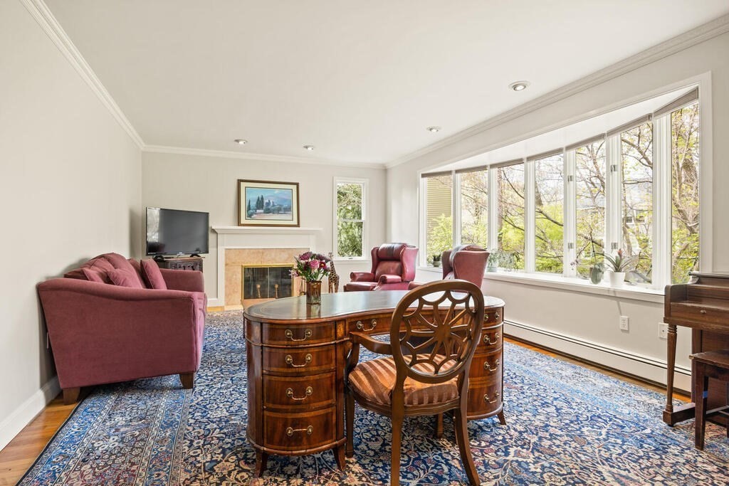 16 Dee Road Lexington, MA 02420 - Photo 4 of 30 a living room with furniture a large window and a fireplace