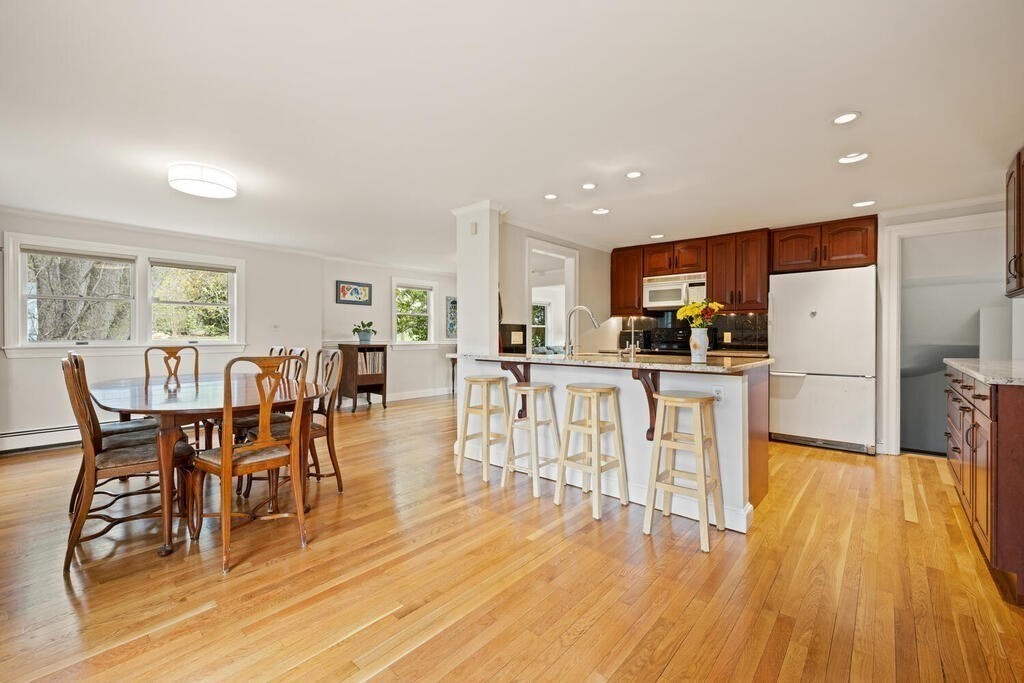 16 Dee Road Lexington, MA 02420 - Photo 7 of 30 a dining room with stainless steel appliances wooden floors a table and chairs