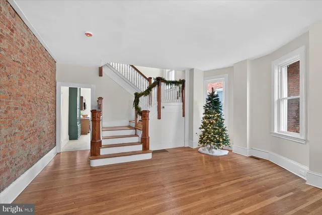a view of entryway and hall with wooden floor