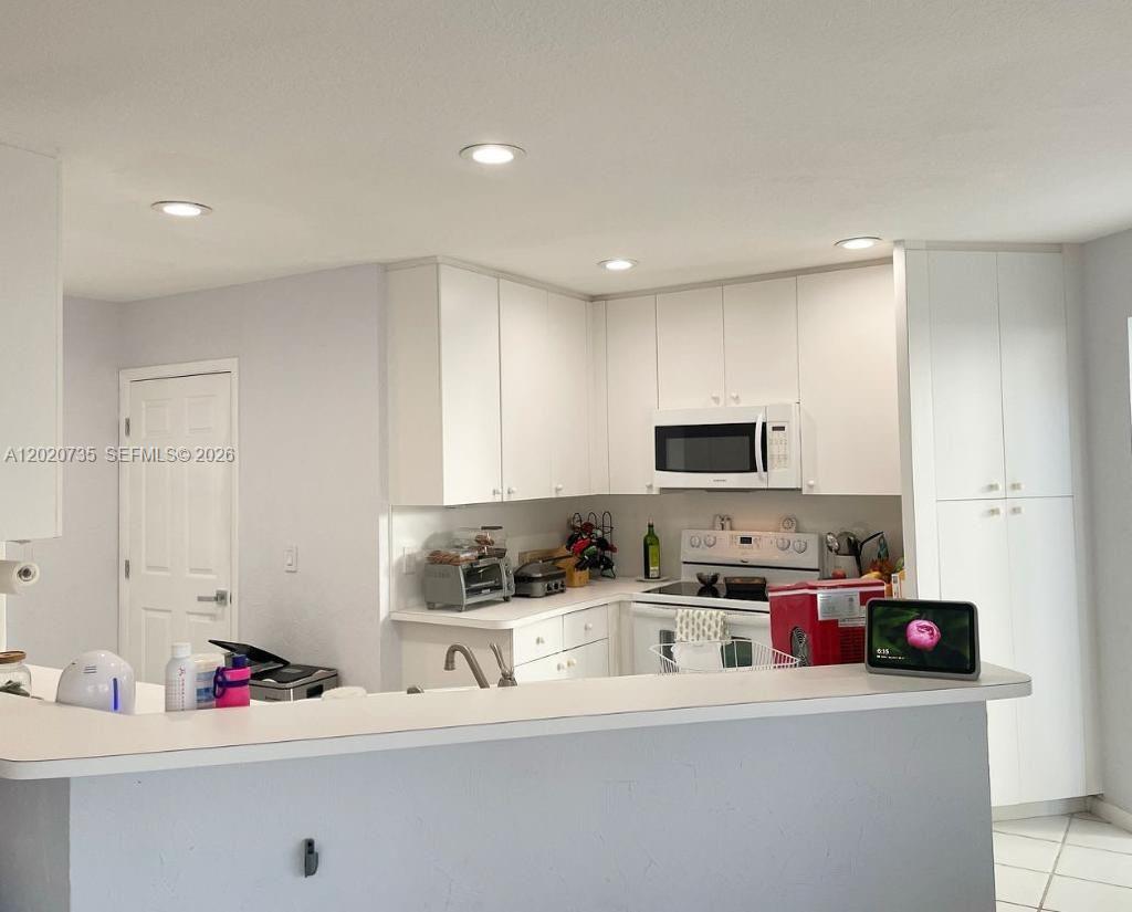 17244 Balboa Point Way Boca Raton, FL 33487 - Photo 8 of 66 a kitchen with kitchen island sink stove top oven and microwave