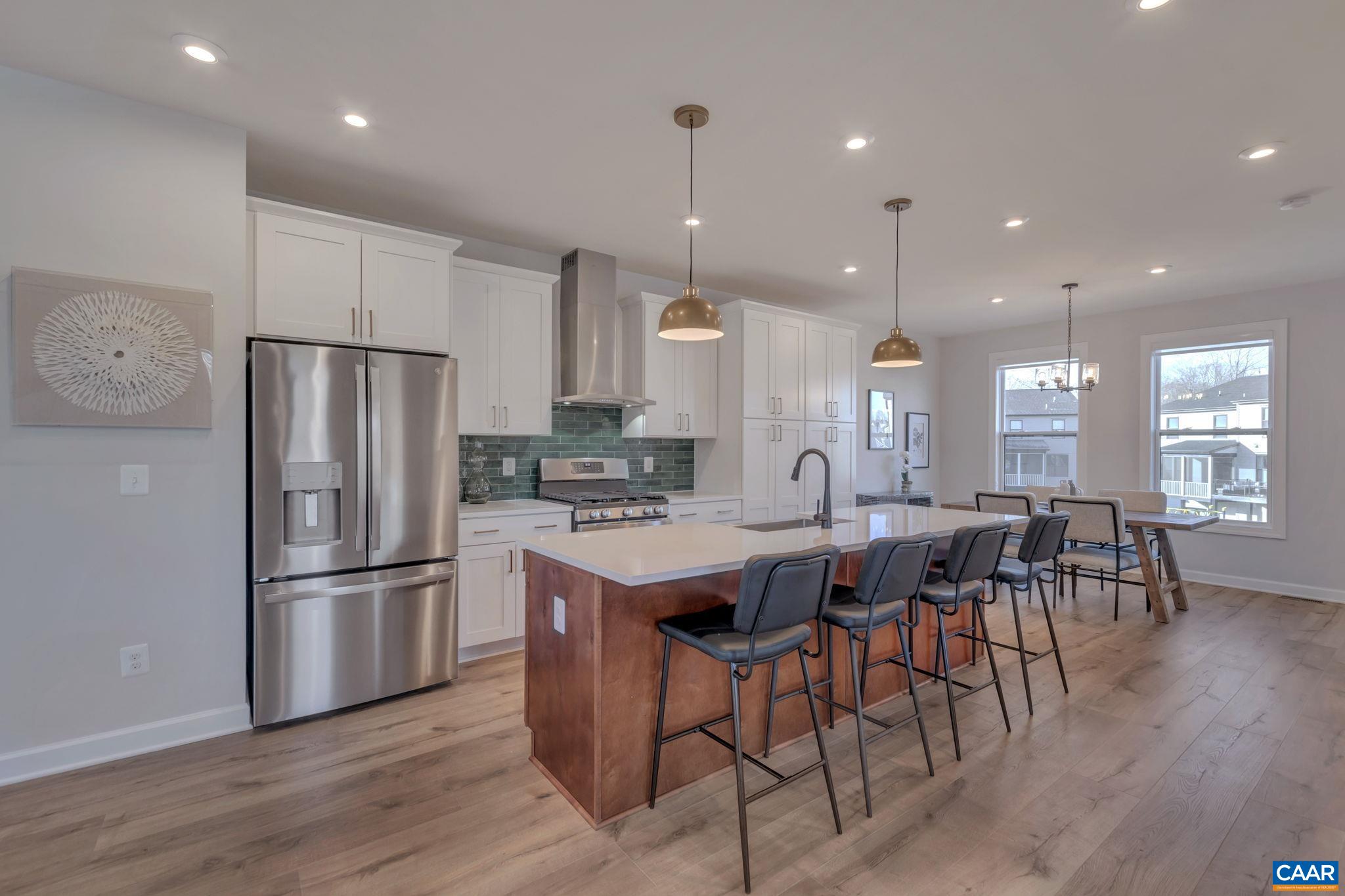 1824 Fowler Street Charlottesville, VA 22901 - Photo 16 of 33 a kitchen with stainless steel appliances granite countertop a refrigerator a stove a sink a dining table and chairs