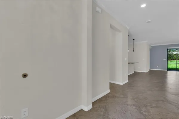 a view of a hallway with wooden shelves