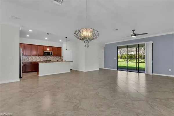 a view of an empty room with a kitchen