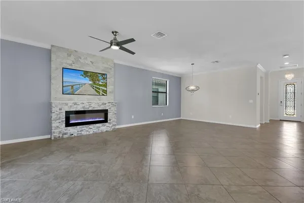 a view of an empty room with a fireplace and a window