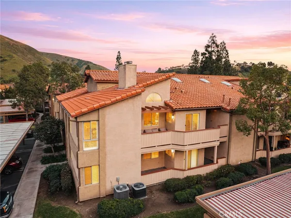 a aerial view of a house with a yard and balcony