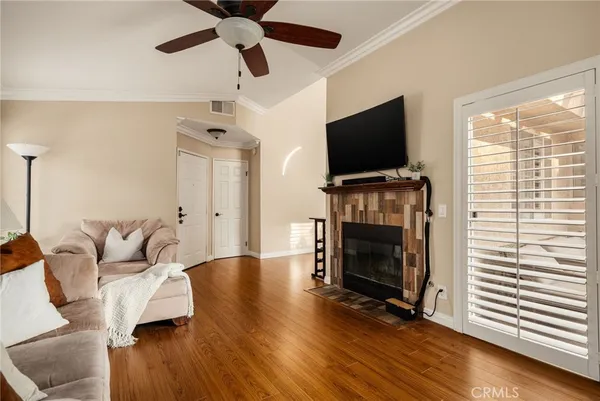 a living room with furniture fireplace and flat screen tv