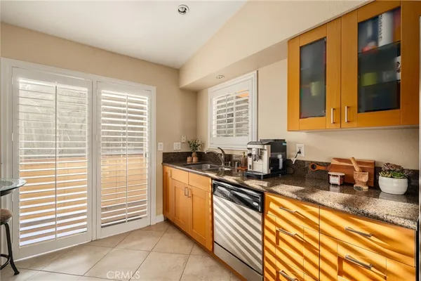 a kitchen with stainless steel appliances granite countertop a sink and a window