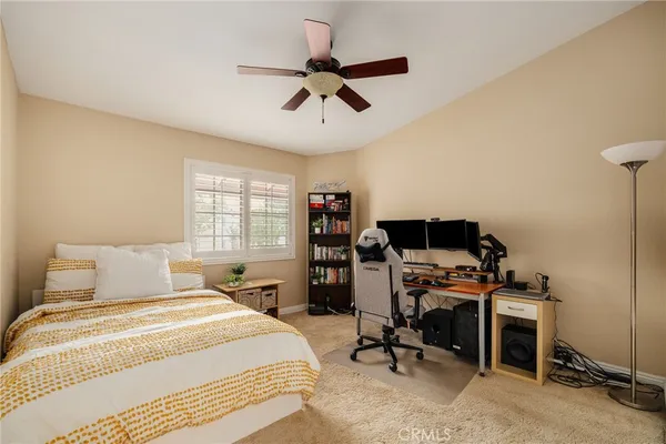 a bedroom with a workspace