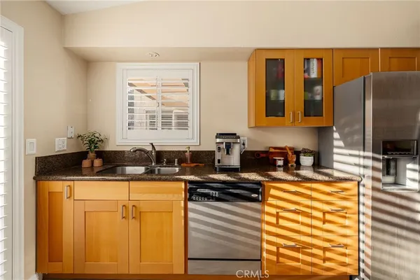 a kitchen with stainless steel appliances granite countertop a sink stove and cabinets