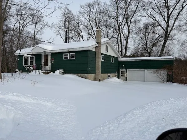 front view of a house with a yard with trees
