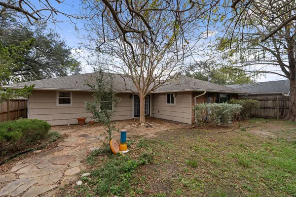 a front view of house with yard and trees