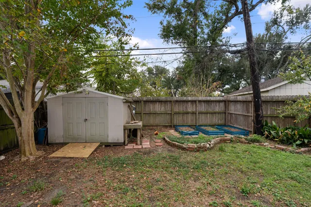 a backyard of a house with barbeque oven
