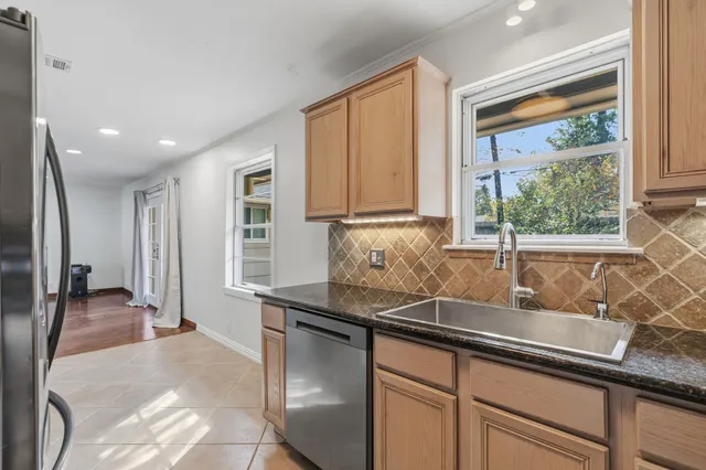 a kitchen with granite countertop a sink and a window