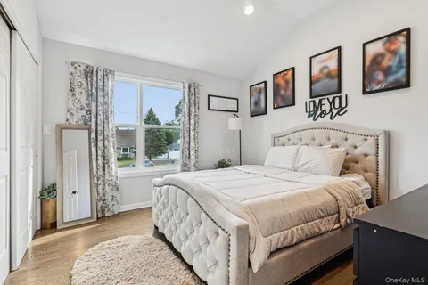 a bedroom with a large bed and a window