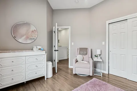 a living room with furniture and a mirror