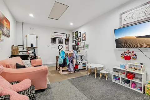 a room with furniture and a flat screen tv