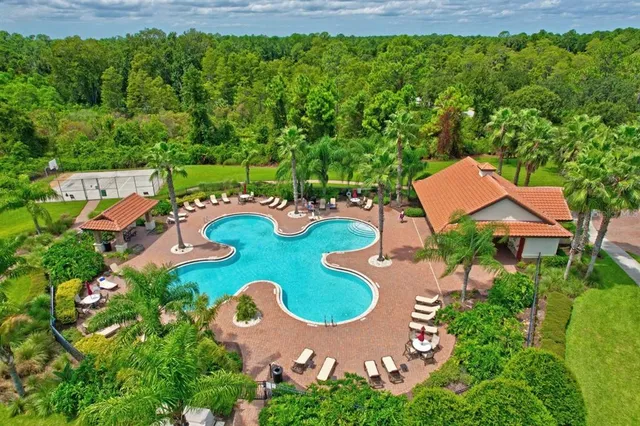 a sign of golf club on a wall under a tree