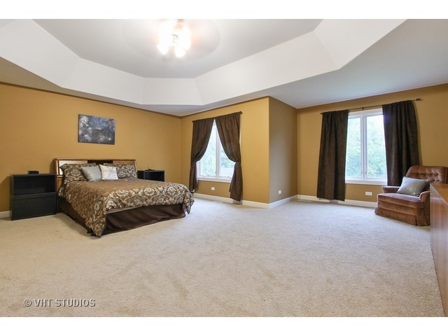 1111 Old York Road Elmhurst, IL 60126 - Photo 9 of 20 a spacious bedroom with a bed a couch and a chandelier