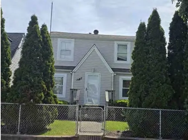 a view of a brick house next to a yard