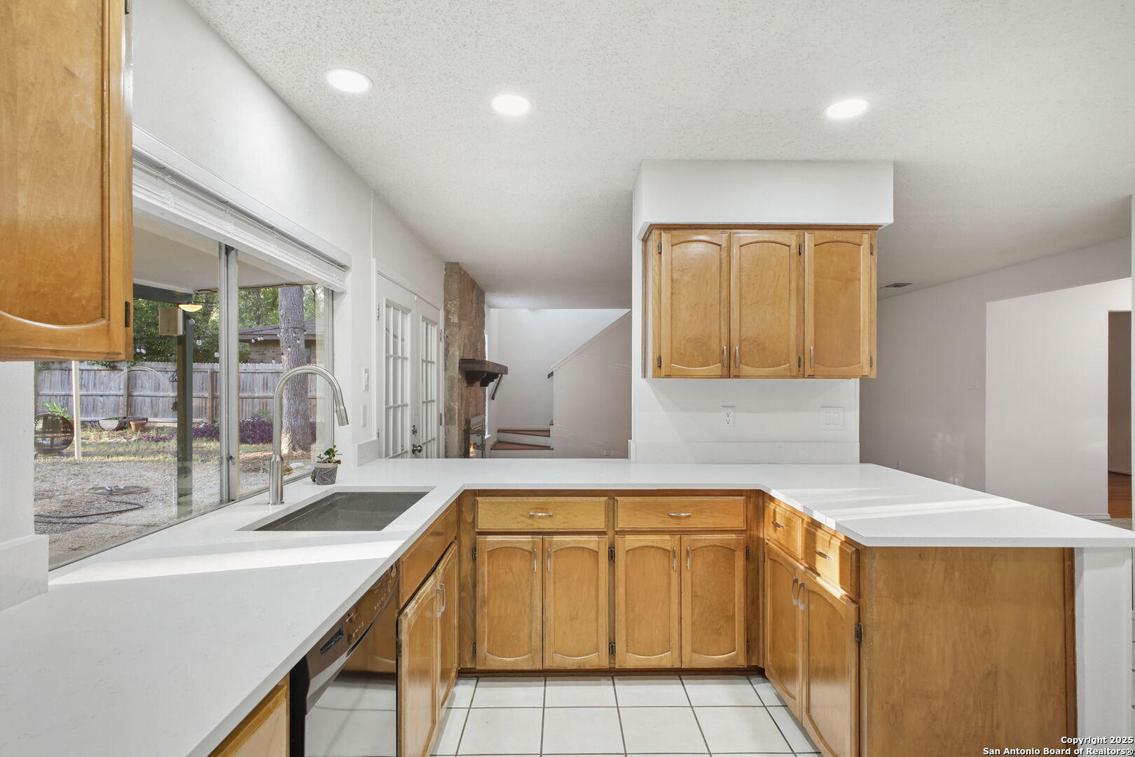 15319 Pebble Path San Antonio, TX 78232 - Photo 12 of 29 a view of a kitchen with a sink and dishwasher with wooden floor