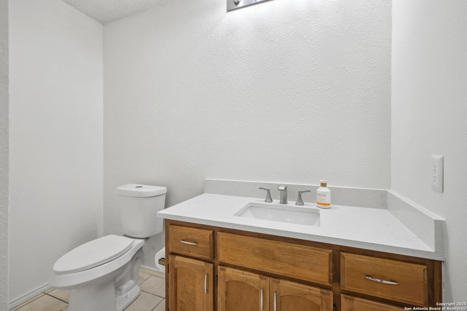 15319 Pebble Path San Antonio, TX 78232 - Photo 14 of 29 a bathroom with a sink toilet and vanity