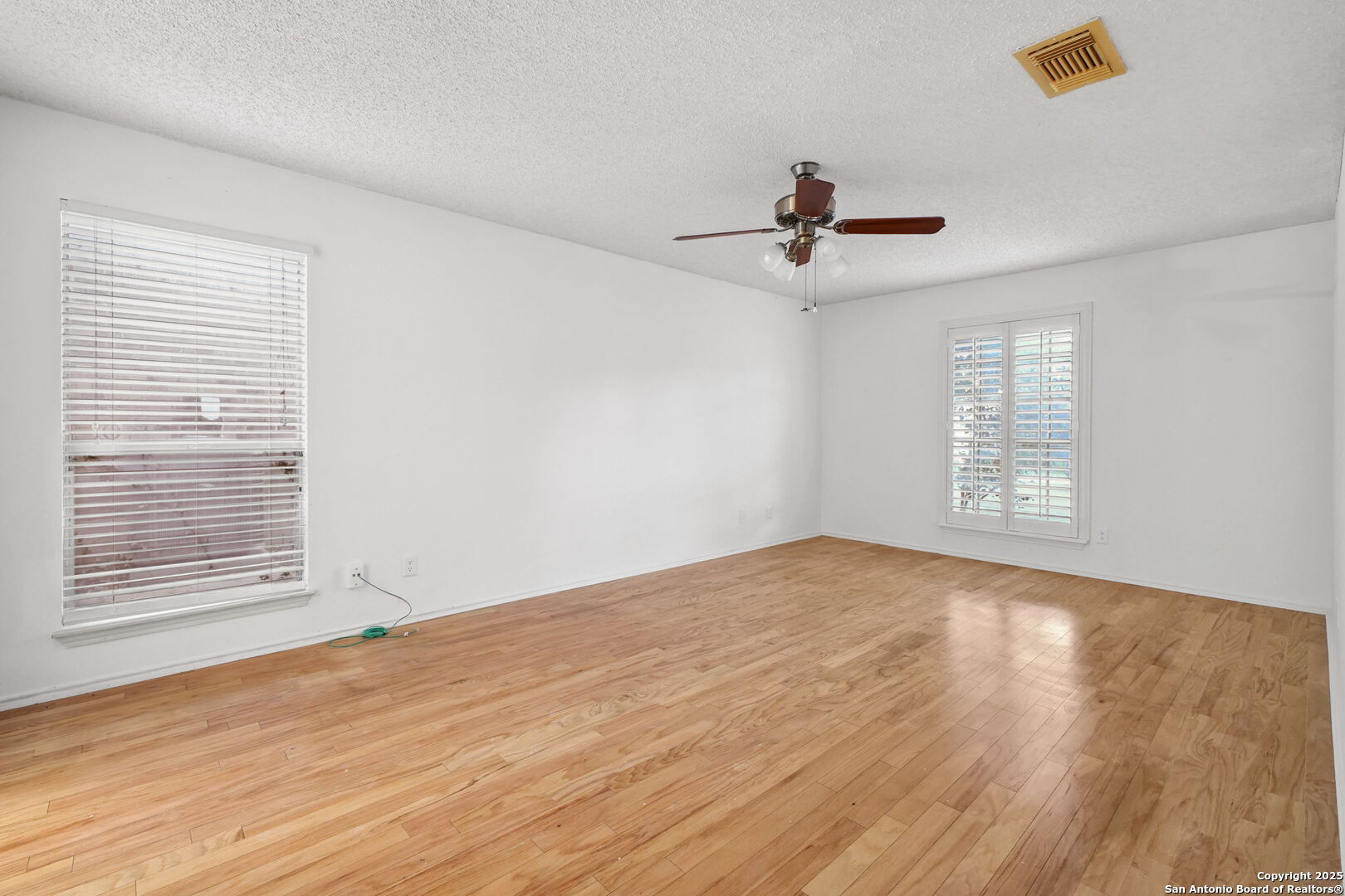 15319 Pebble Path San Antonio, TX 78232 - Photo 15 of 29 a view of an empty room with glass window and chandelier fan