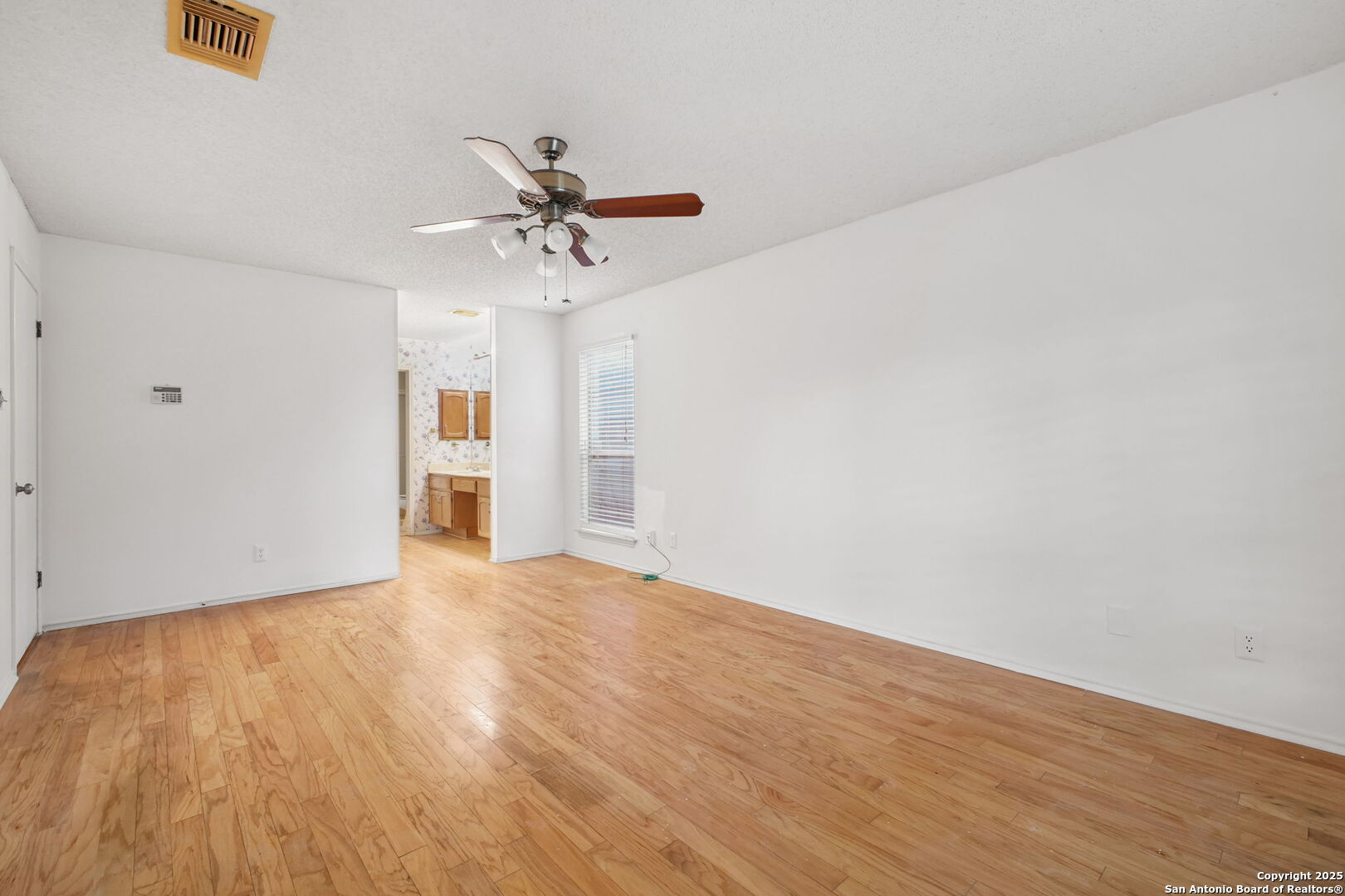 15319 Pebble Path San Antonio, TX 78232 - Photo 16 of 29 a view of empty room with wooden floor and ceiling fan