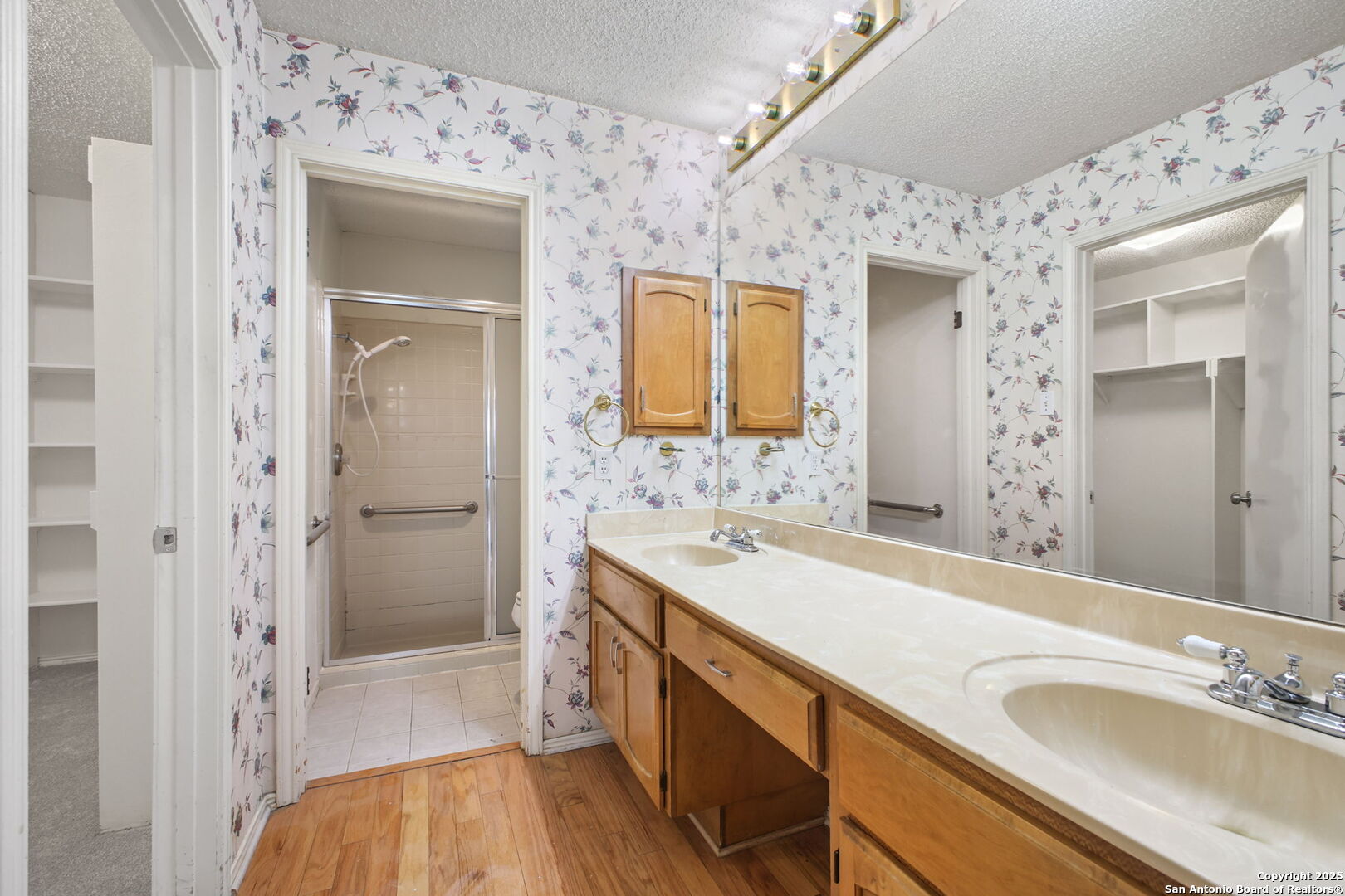 15319 Pebble Path San Antonio, TX 78232 - Photo 17 of 29 a spacious bathroom with a sink a mirror and a shower