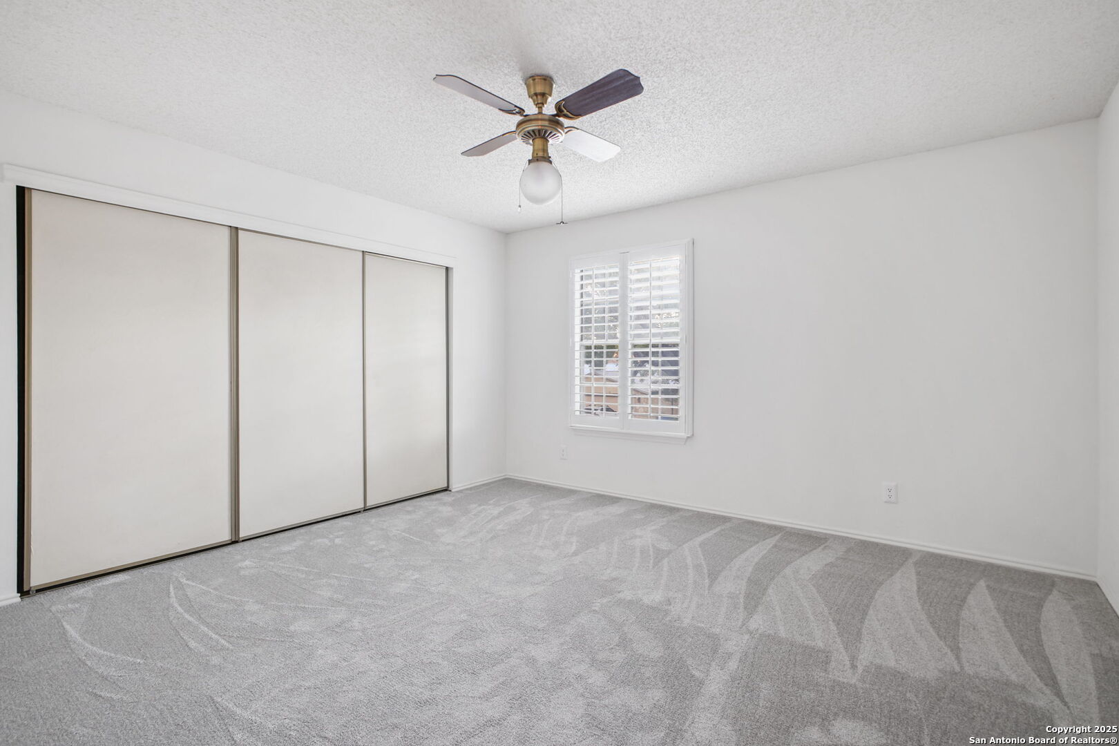 15319 Pebble Path San Antonio, TX 78232 - Photo 21 of 29 an empty room with ceiling fan and windows
