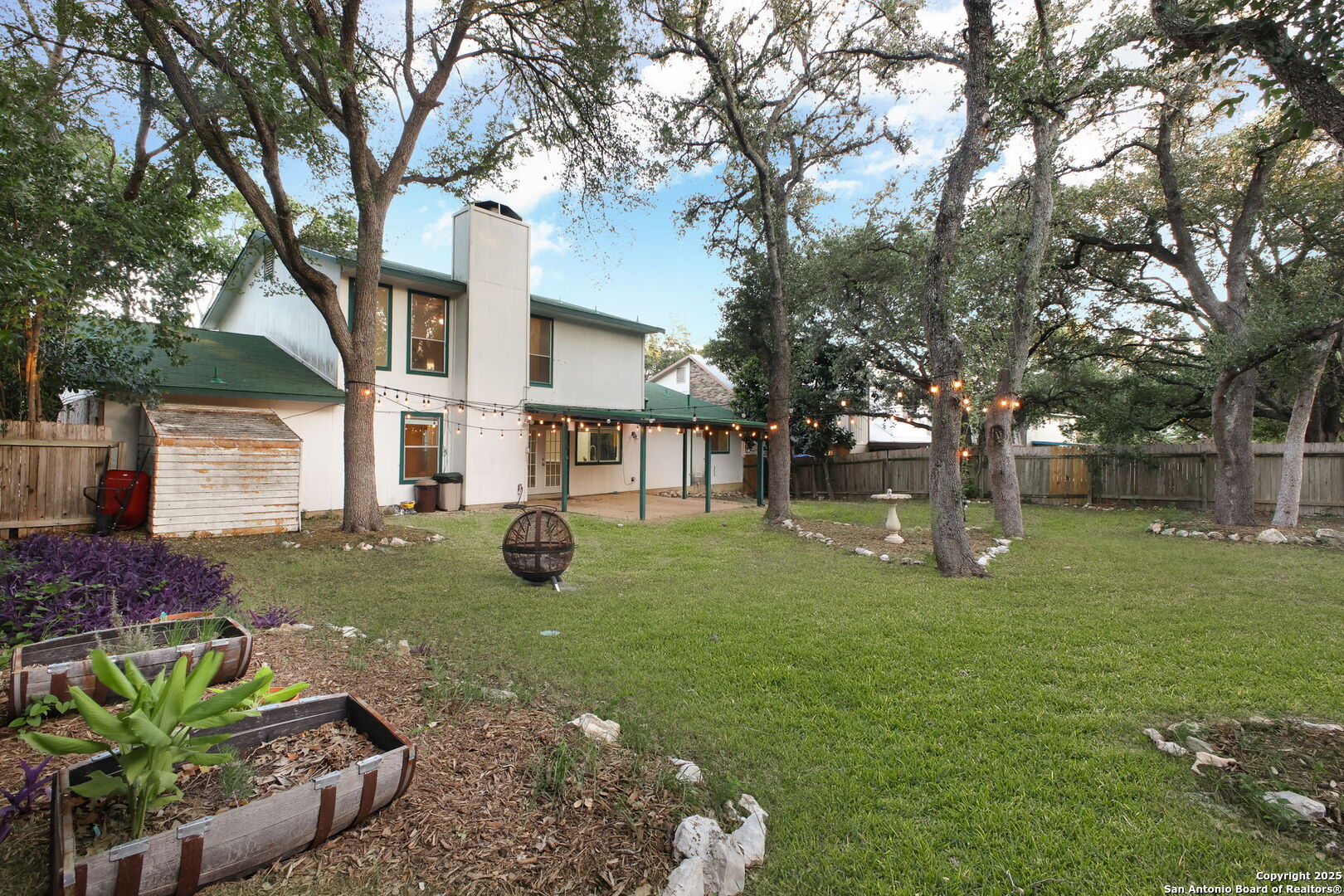 15319 Pebble Path San Antonio, TX 78232 - Photo 25 of 29 a view of a yard with plants and a tree