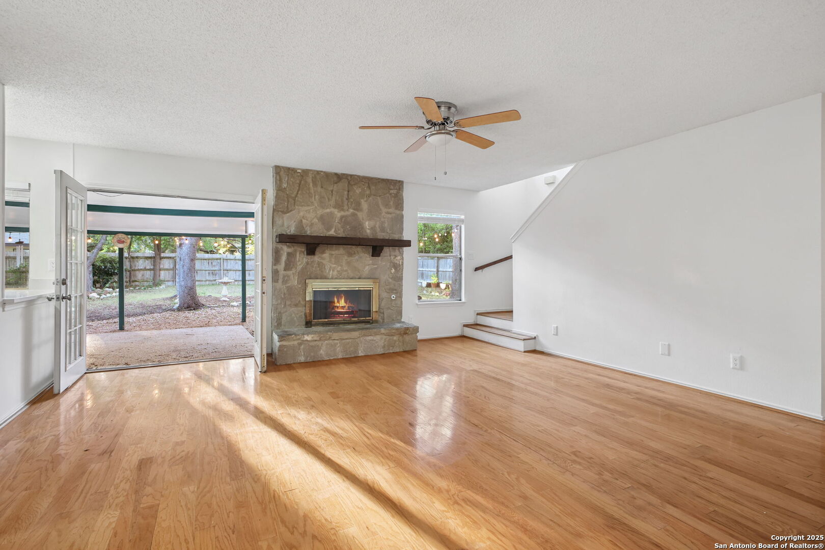 15319 Pebble Path San Antonio, TX 78232 - Photo 7 of 29 a view of empty room with wooden floor and fireplace