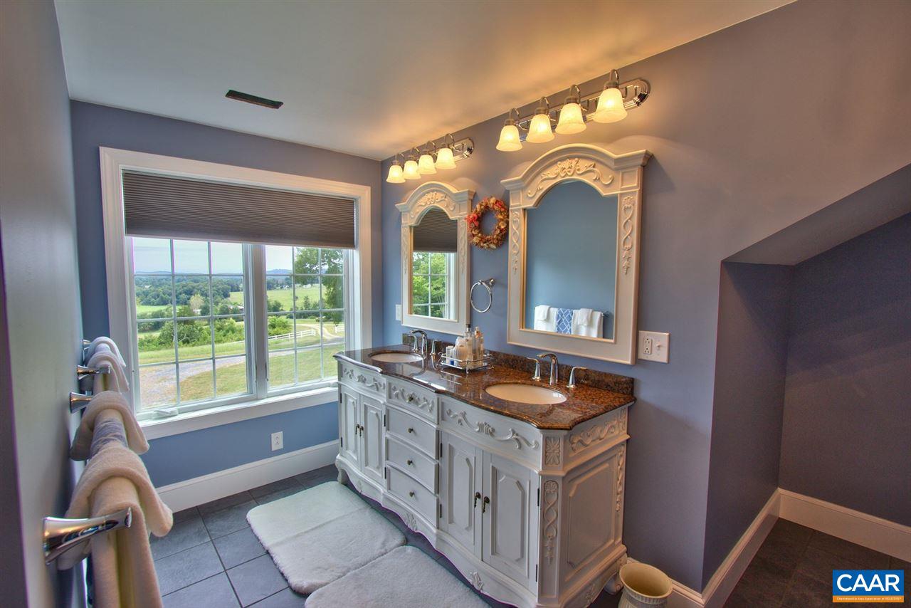 2711 Lowesville Road Roseland, VA 22967 - Photo 21 of 32 a spacious bathroom with a vanity a sink and a mirror