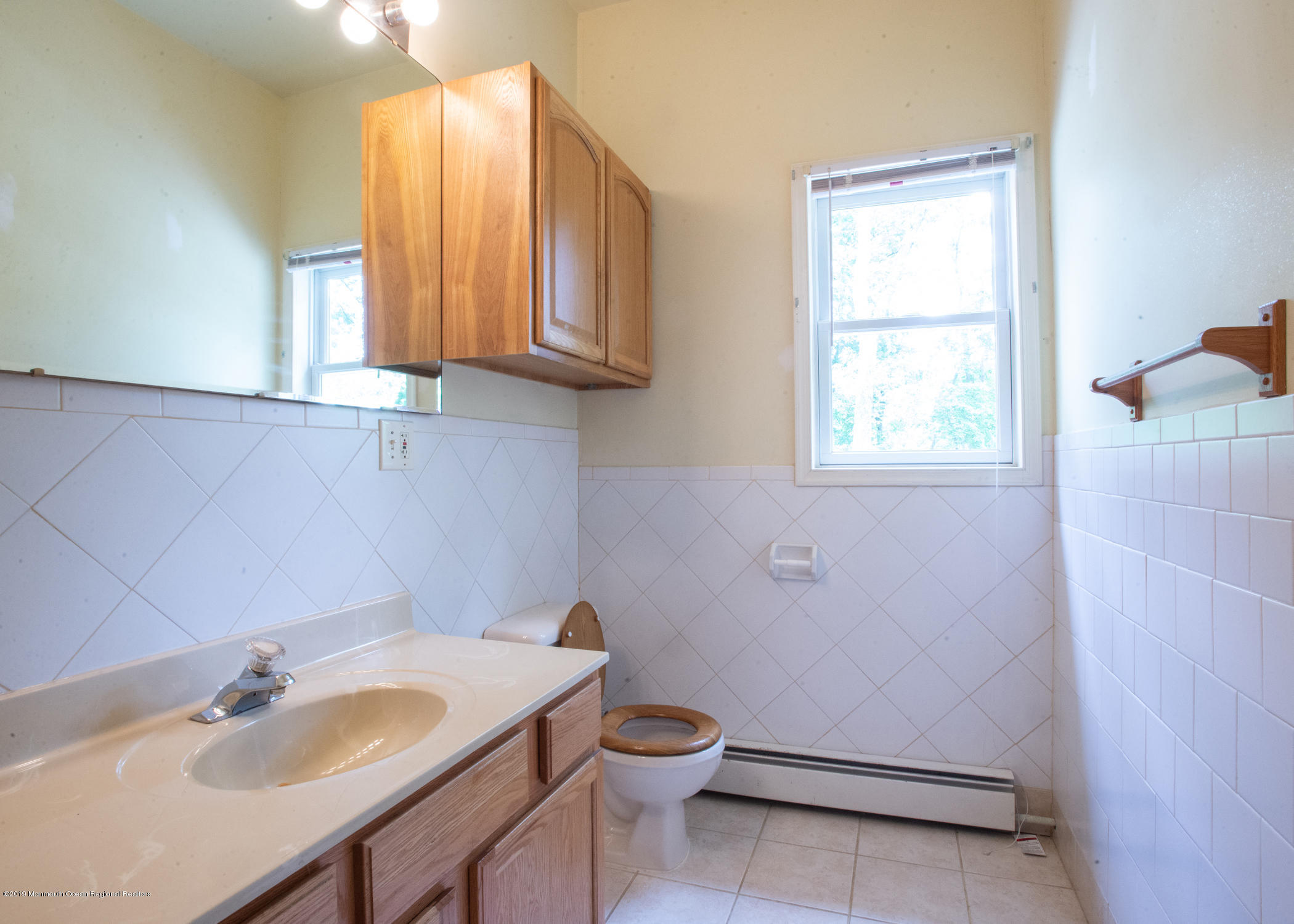 802 West Farms Road Howell, NJ 07731 - Photo 14 of 16 a bathroom with a sink a toilet and a window