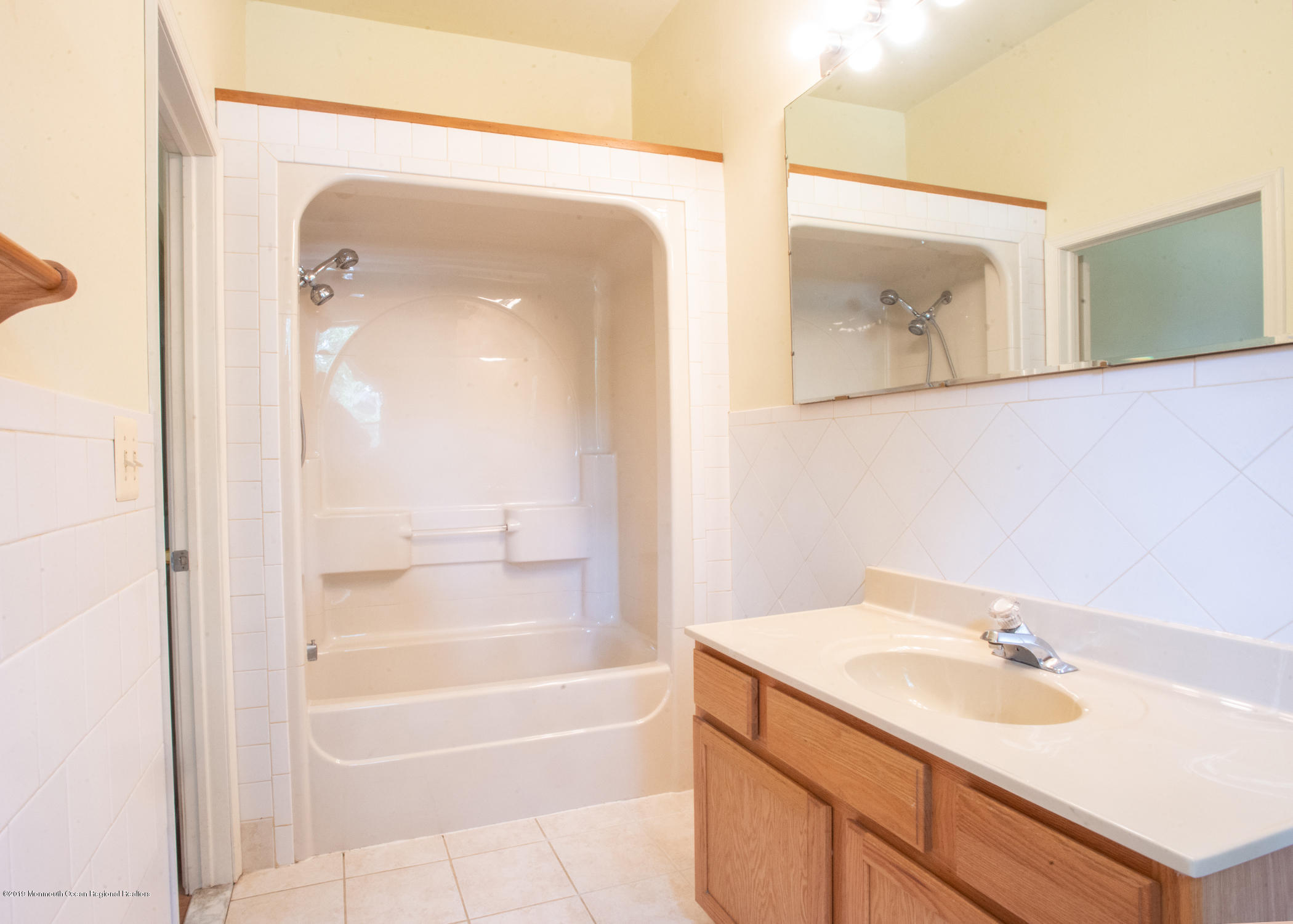 802 West Farms Road Howell, NJ 07731 - Photo 15 of 16 a bathroom with a sink a mirror and a bathtub