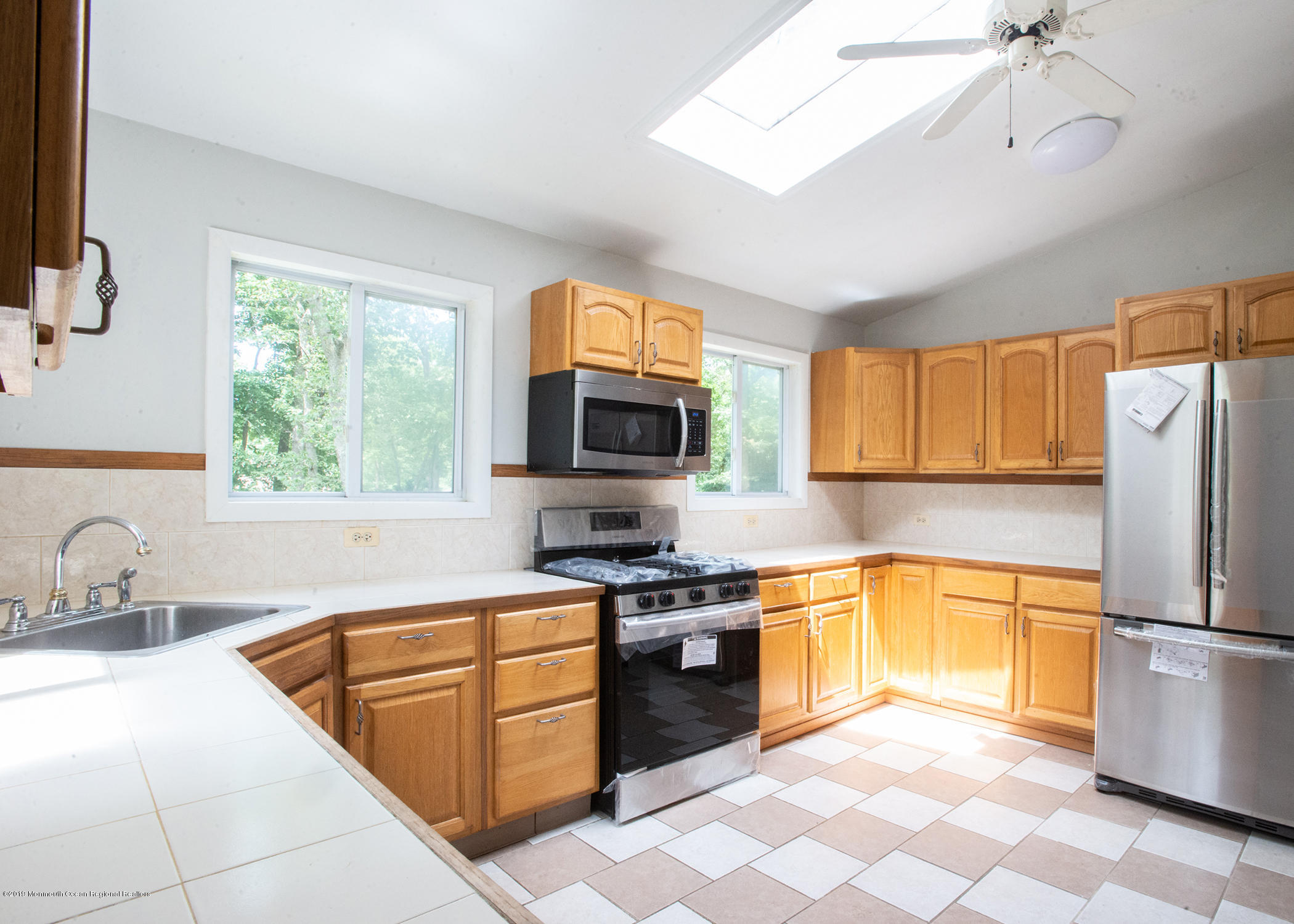 802 West Farms Road Howell, NJ 07731 - Photo 4 of 16 a kitchen with stainless steel appliances granite countertop a stove a sink and a refrigerator