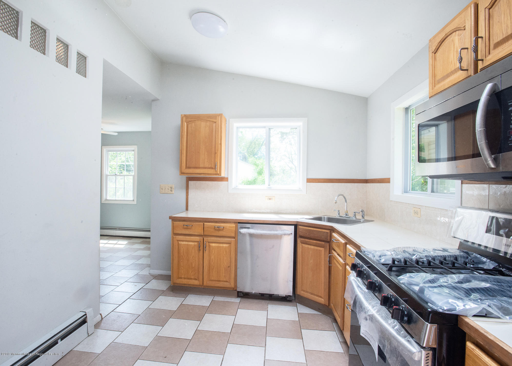 802 West Farms Road Howell, NJ 07731 - Photo 5 of 16 a kitchen with stainless steel appliances granite countertop a sink stove and cabinets