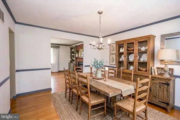 a view of a room with wooden floor chandelier and a window