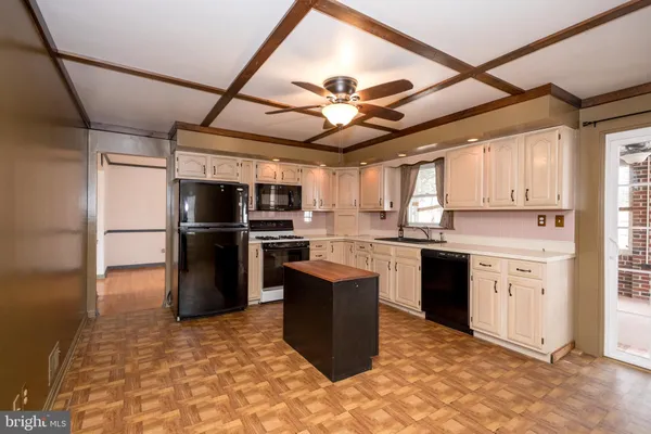 a large kitchen with stainless steel appliances granite countertop a stove a sink dishwasher and a refrigerator