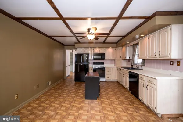 a kitchen with a refrigerator and a sink