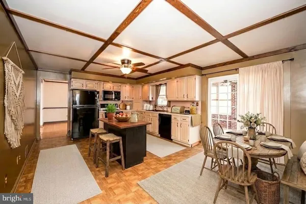 a kitchen with granite countertop a sink cabinets stainless steel appliances and a counter top space