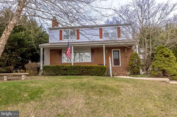 a view of a brick house with a yard