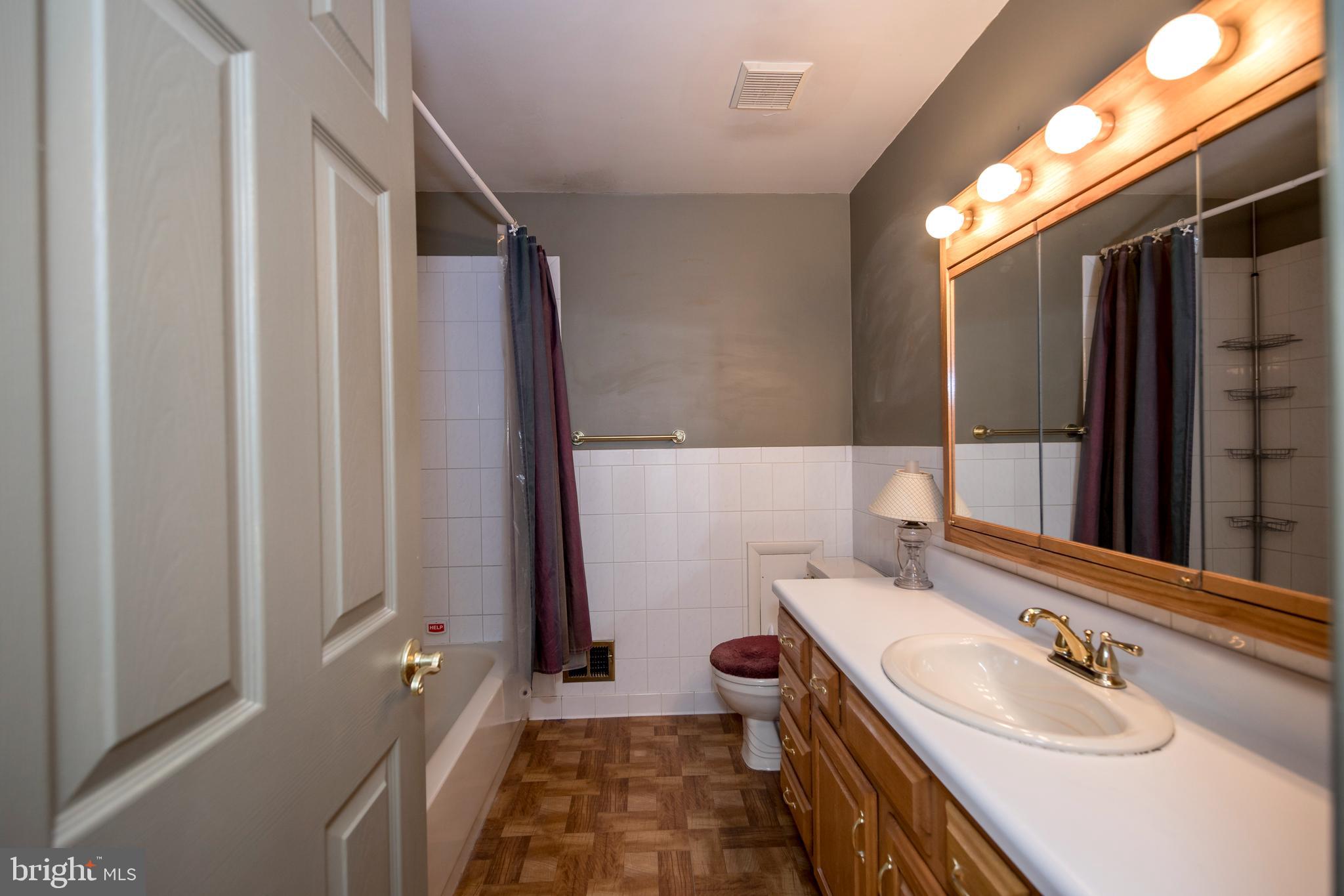 4300 Camellia Road Nottingham, MD 21236 - Photo 30 of 47 a bathroom with a double vanity sink and mirror